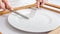 Closeup image of woman loosing weight eating pill with fork and knife on empty dish