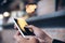 Closeup image of woman`s hands holding and touching white mobile phone