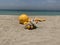 Closeup image of a yellow buoy washed up on the shore