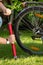 Closeup image of young man pumping flat bicycle tire