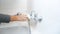 Closeup image of young woman cleaning water faucet in bathroom with detergent