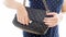 Closeup image of young woman locking her black leather handbag