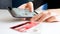 Closeup image of young woman making online order on smartphone and paying with credit card