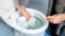 Closeup image of young woman pouring cleaning antibacterial liquid in toilet