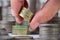 Closeup of an index finger taps on a stack of british pound coin