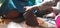 Closeup Indian Girl grinding Masala or Chutney in a traditional way using grinding stones