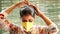 Closeup of an Indian women showing how to wear a safety N95 mask and eye-protection