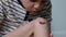 Closeup of injured young kid`s knee. Boy inspecting his wounded scraped leg. Abrasions on the boy`s leg