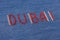 Closeup inscription Dubai, inlaid rhinestones on denim.