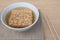 Closeup Instant noodles in white dish and chopsticks on wood background.