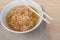 Closeup Instant noodles in white dish and chopsticks on wood background.