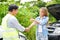 Closeup insurance company officers are congratulatory handshake with customer thumbs up after completing the insurance claim