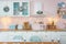 Closeup of interior of modern white kitchen with pink walls and blue decor on a Christmas New year eve