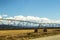 Closeup of Irrigation Systems for Farm Management in roadside field with mountains in distance and beautiful blue sky with clouds