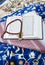 Closeup of Islamic book Quran rosary and shemagh scent bottle on colorful prayer mat,religious