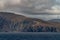 Closeup of island cliffs under cloudscape, Cape Horn, Chile