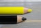 Closeup of isolated colorful yellow and black crayons on wood background - german parties FDP and CDU coalition concept