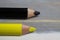 Closeup of isolated colorful yellow and black crayons on wood background - german parties FDP and CDU coalition concept