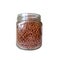 Closeup of an isolated glass jar with dry food. Transparent jar with brown granules.