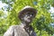 Closeup of isolated painter Vincent van Gogh bronze sculpture in dutch park