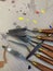 Closeup of isolated spatulas, painting tools on a cardboard background with drops of colored paint on an art lab