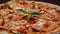 Closeup Italian Pizza on White Plate against Black Table