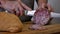 Closeup of Italian sopressa salami with homemade bread with knife and being cut