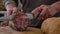 Closeup of Italian sopressa salami with homemade bread with knife and being cut