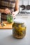 Closeup on jar of marinated cucumbers on table