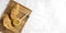 Closeup of jar of sweet honey and croissants on the wooden board against empty background