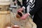 Closeup of a Jewish man using a copper cup for ritual hand washing prior to prayer.