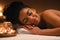 Closeup of joyful black lady sleeping at spa salon