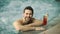 Closeup joyful man having fun in whirlpool bath. Smiling man relaxing pool spa