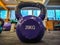 Closeup of kettlebell as round ball shaped dumbbell of 20 kilograms placed on the gym floor interior for weight loss and