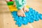 Closeup of kid feet while standing on special massaging mat