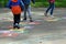 Closeup of kids feet jumping and playing hopscotch at school