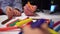 Closeup kids hands drawing together on big paper with focus on colored markers