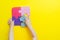 Closeup of kids hands playing with puzzles on yellow background