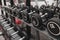 Closeup of kilogram dumbbells placed on a dumbbell rack at the gym. Weight training equipment.