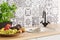 Closeup of kitchen sink and herbs and fruit on counter