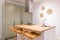 Closeup of kitchen table with trendy design high chairs. Wooden top and chairs in single honey color palette. Countertop