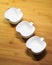 Closeup kitchenware, 3 white ceramic bowls of apple shape design on wood dining table background