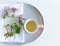 Closeup of Lamium amplexicaule, commonly known as common henbit, or greater henbit, earthenware plate, cotton towel on white table