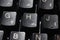 Closeup of laptop computer keyboard black keys with white letters and numbers