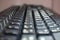 Closeup of laptop computer keyboard black keys with white letters and numbers