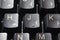 Closeup of laptop computer keyboard black keys with white letters and numbers