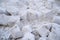 Closeup of large chunks of dirty snow, from a snowplow, on the street