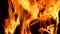 Closeup of a large fire. Wooden planks to the fire.