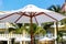 Closeup of a large white sunshade near the swimming pool during daylight