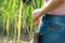 Closeup of a Latina girl& x27;s hand, taking a machete out of its cover, cutting sugar cane